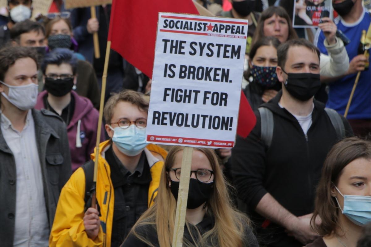 system broken revolution placard